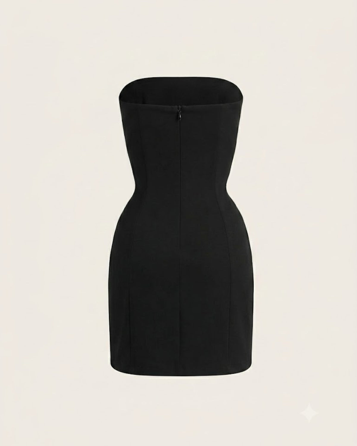 The Odile Dress photographed alone against cream — back view, showing the single zipper seam.
