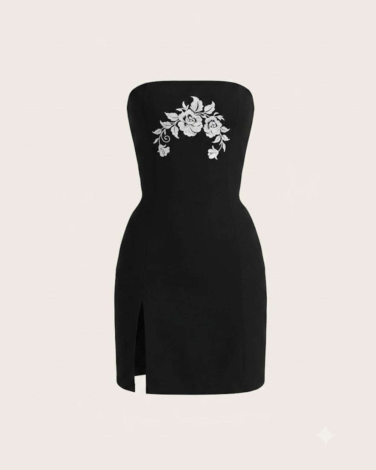 The Odile Dress photographed alone against cream — front view, showing the chest embroidery and the front slit.